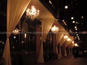 Elegant Event Lighting's signature draping and chandeliers create the perfect ambience on the stunning patio at River Roast Chicago.
